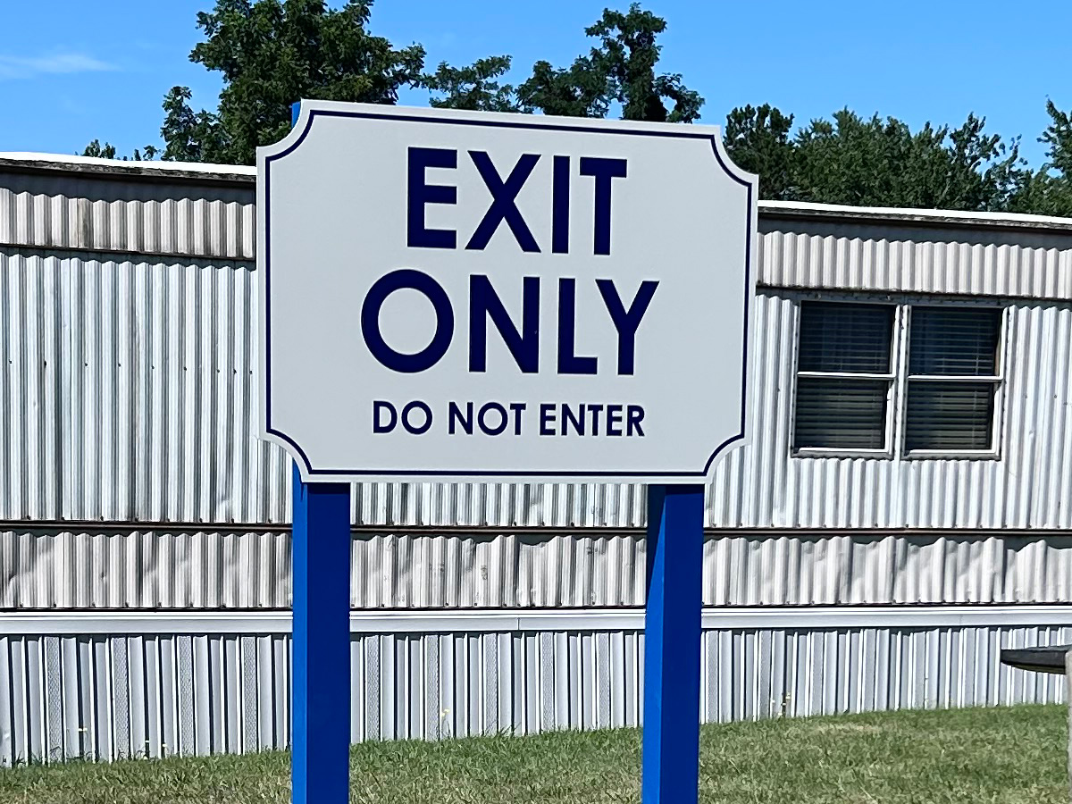 Large Exit Only Do Not Enter traffic-control sign mounted on blue posts in Asheville North Carolina