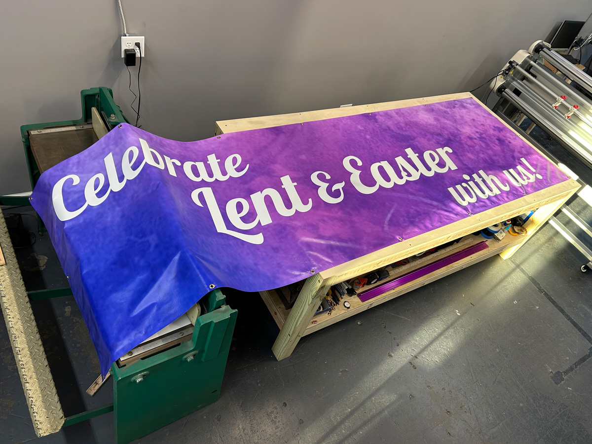 Custom shaped purple and blue church banner reading Celebrate Lent and Easter with us