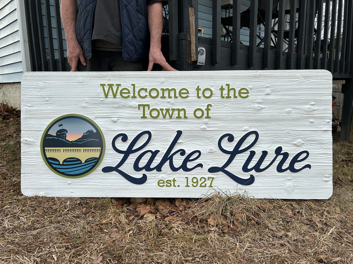 Welcome to the Town of Lake Lure dimensional carved sign with wood-grain texture and logo in Lake Lure North Carolina