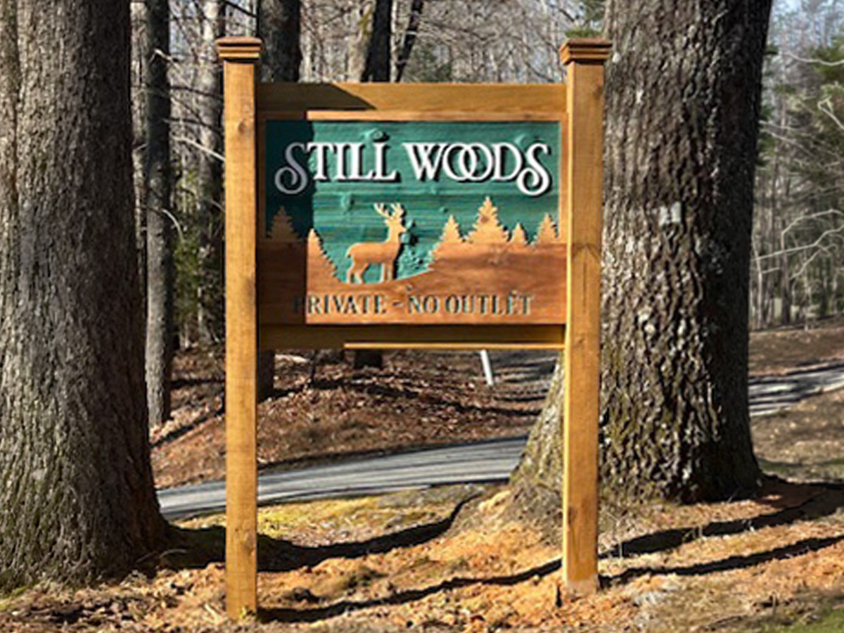 Still Woods private residence sign with dimensional deer and forest design in Brevard North Carolina