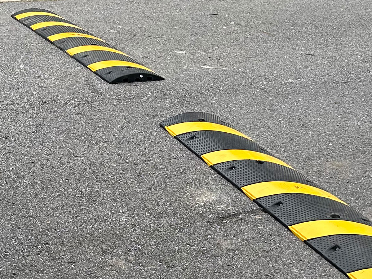Black and yellow speed bumps installed for a private community in Candler North Carolina