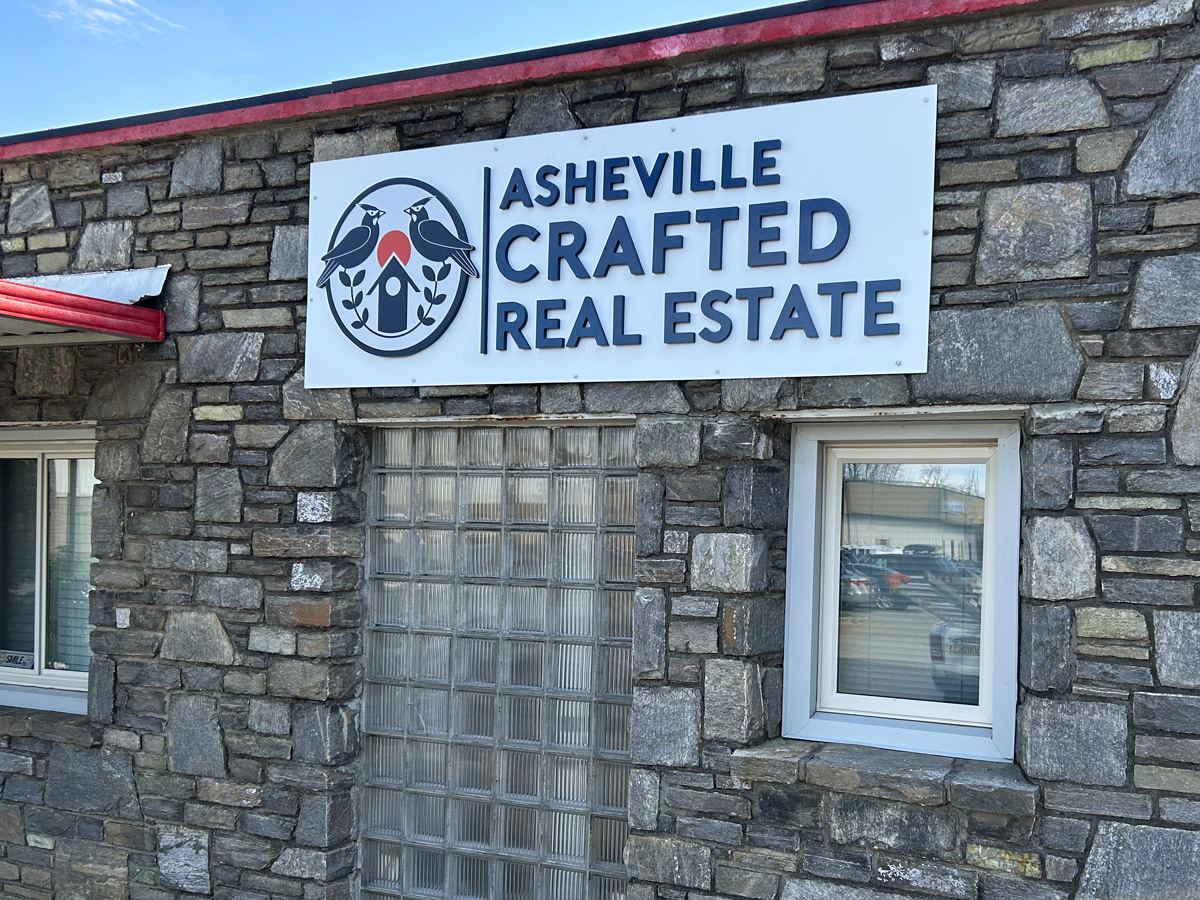 Building sign attached to a rock wall
