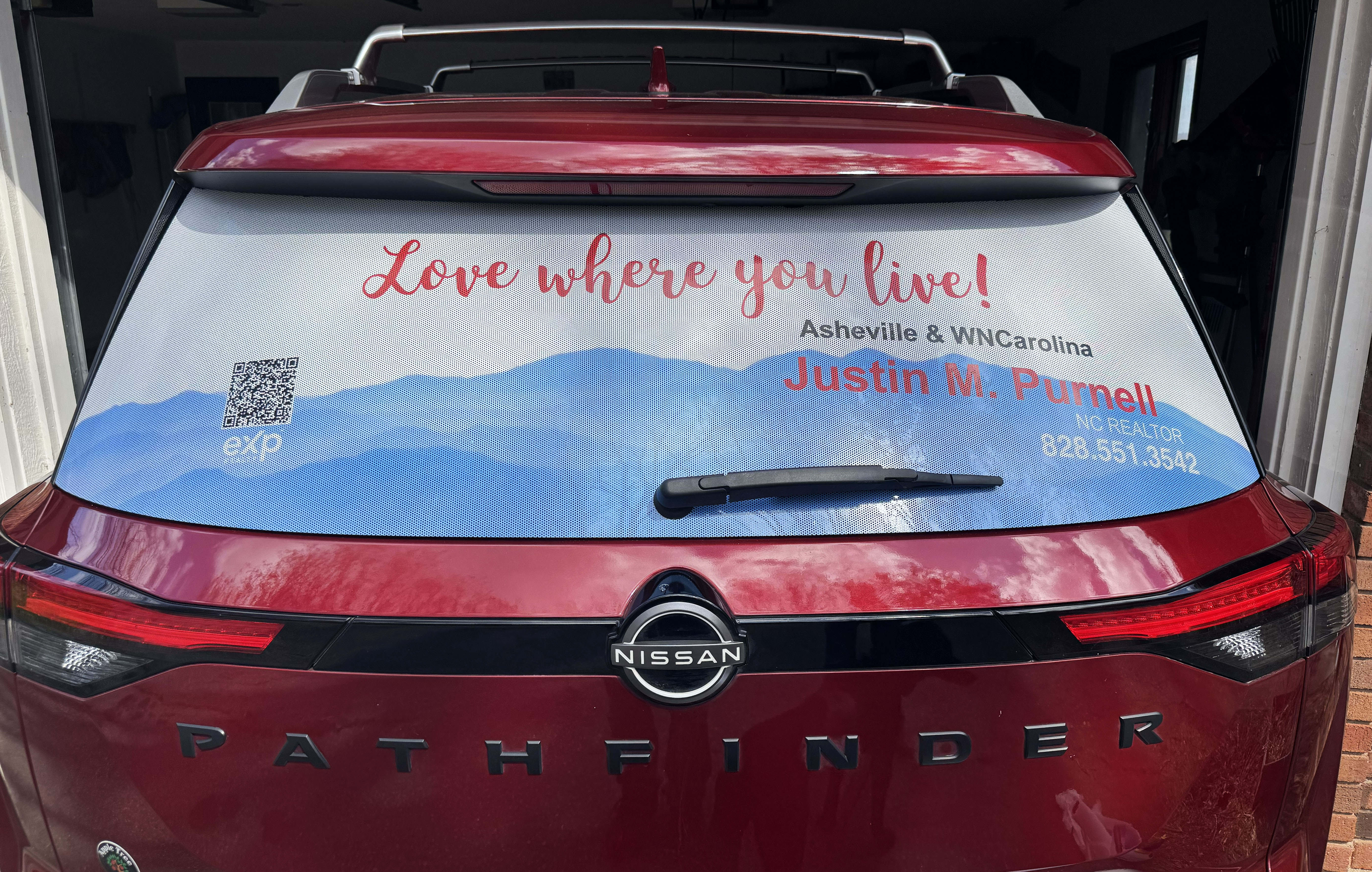 Nissan Pathfinder with perforated rear window advertising graphics