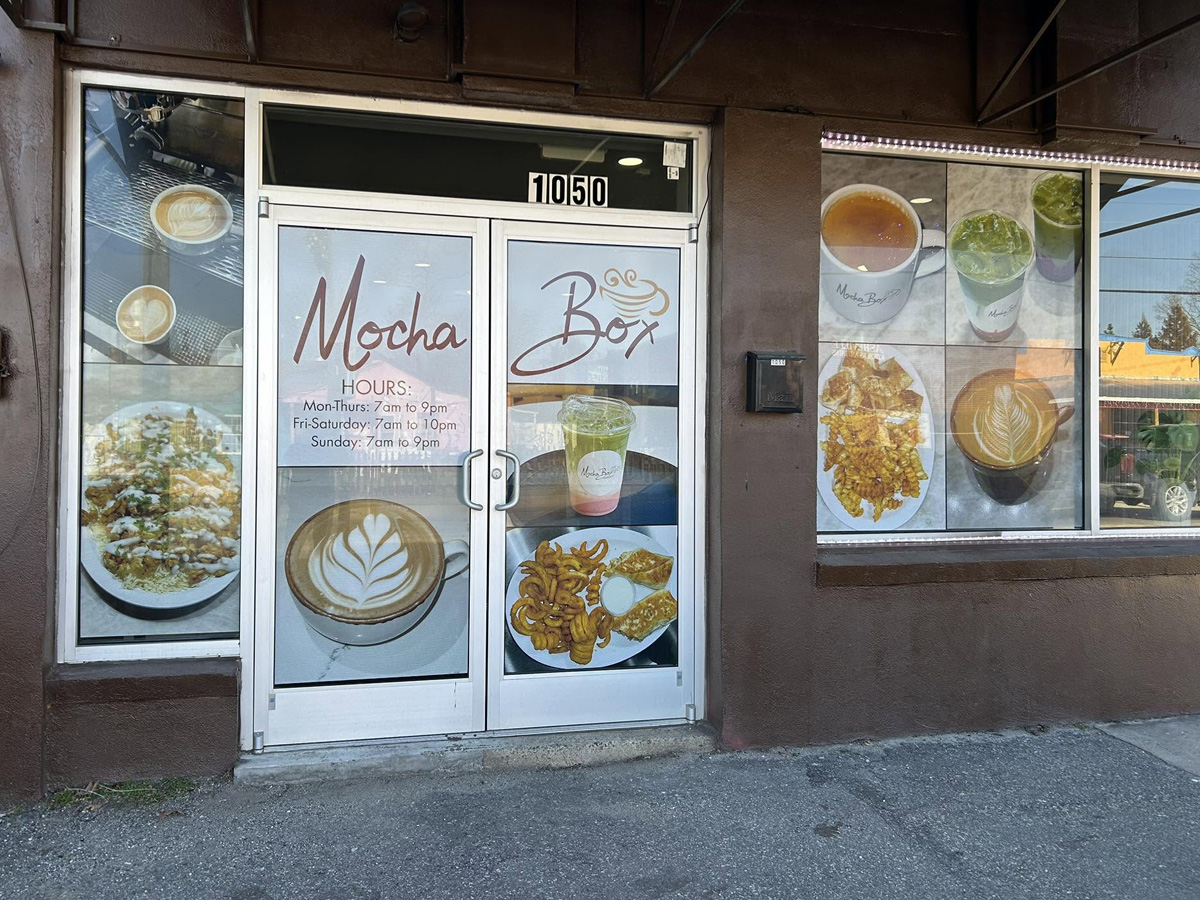 Custom window graphics installed on a local business
