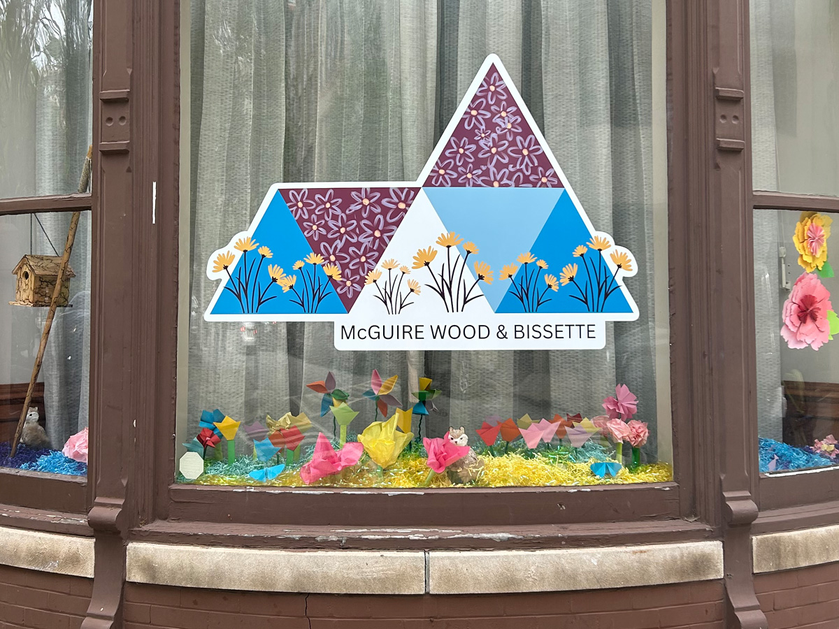 McGuire Wood and Bissette colorful mountain and flower window graphic installed on a storefront display window